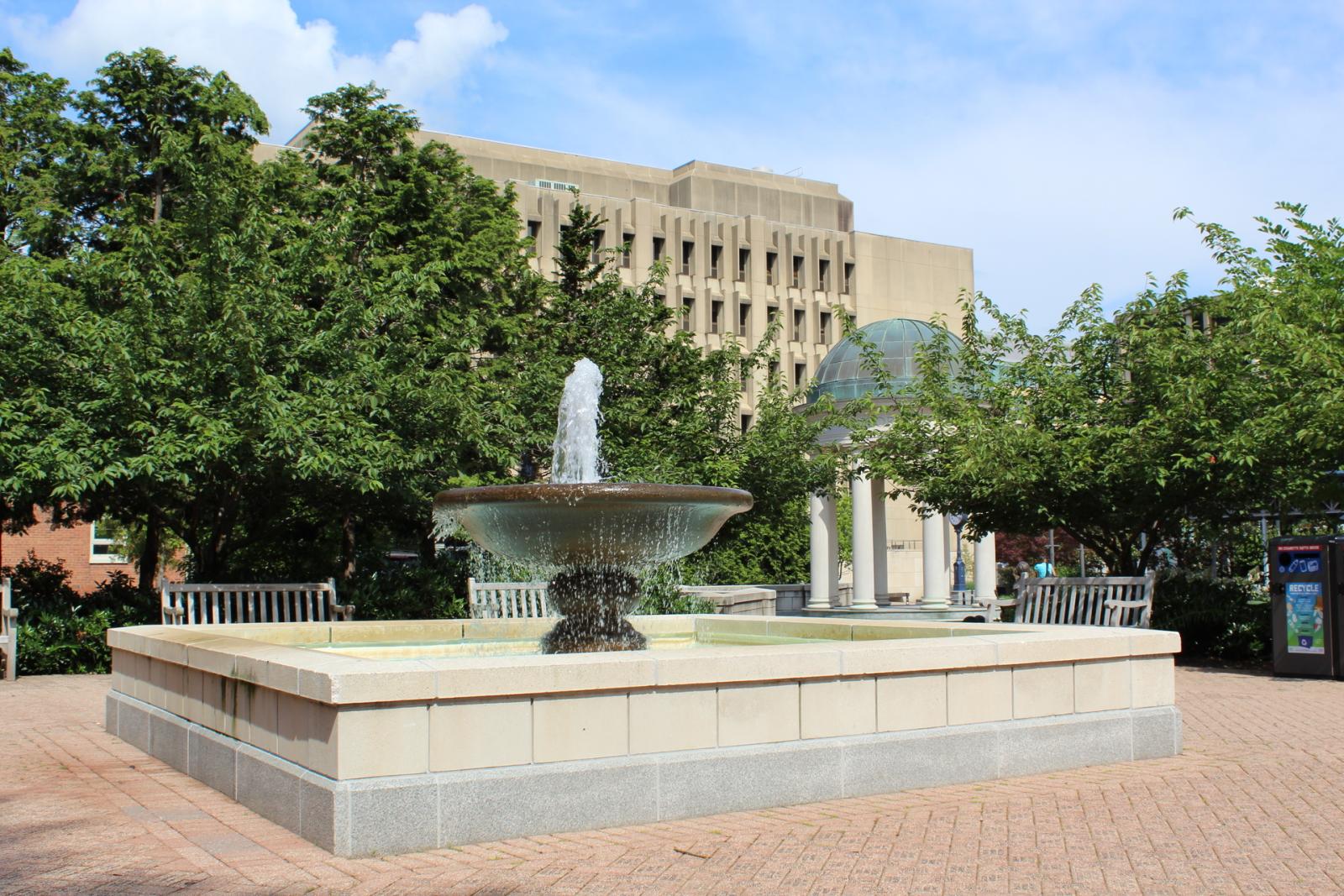 The Kogan Plaza fountain is in the foreground, with the Tempietto in the background on a sunny spring day